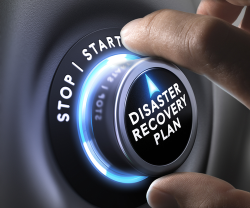A hand turning a dial with the words Disaster Recovery on the outer part