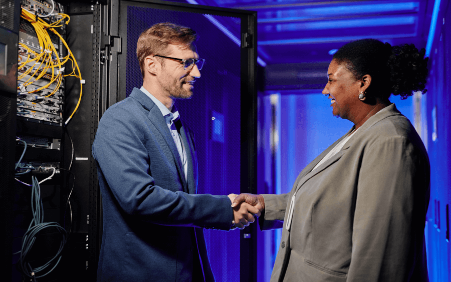 Business people shaking hands in a datacentre